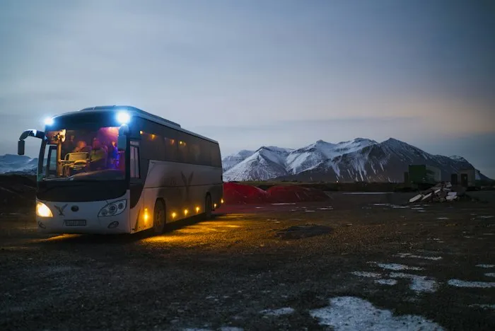 Luxury touring coach at dusk in the mountains