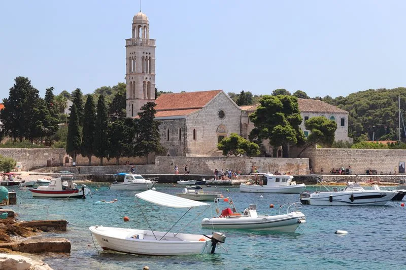 Boats moored beside the monastery bell tower at Hvar