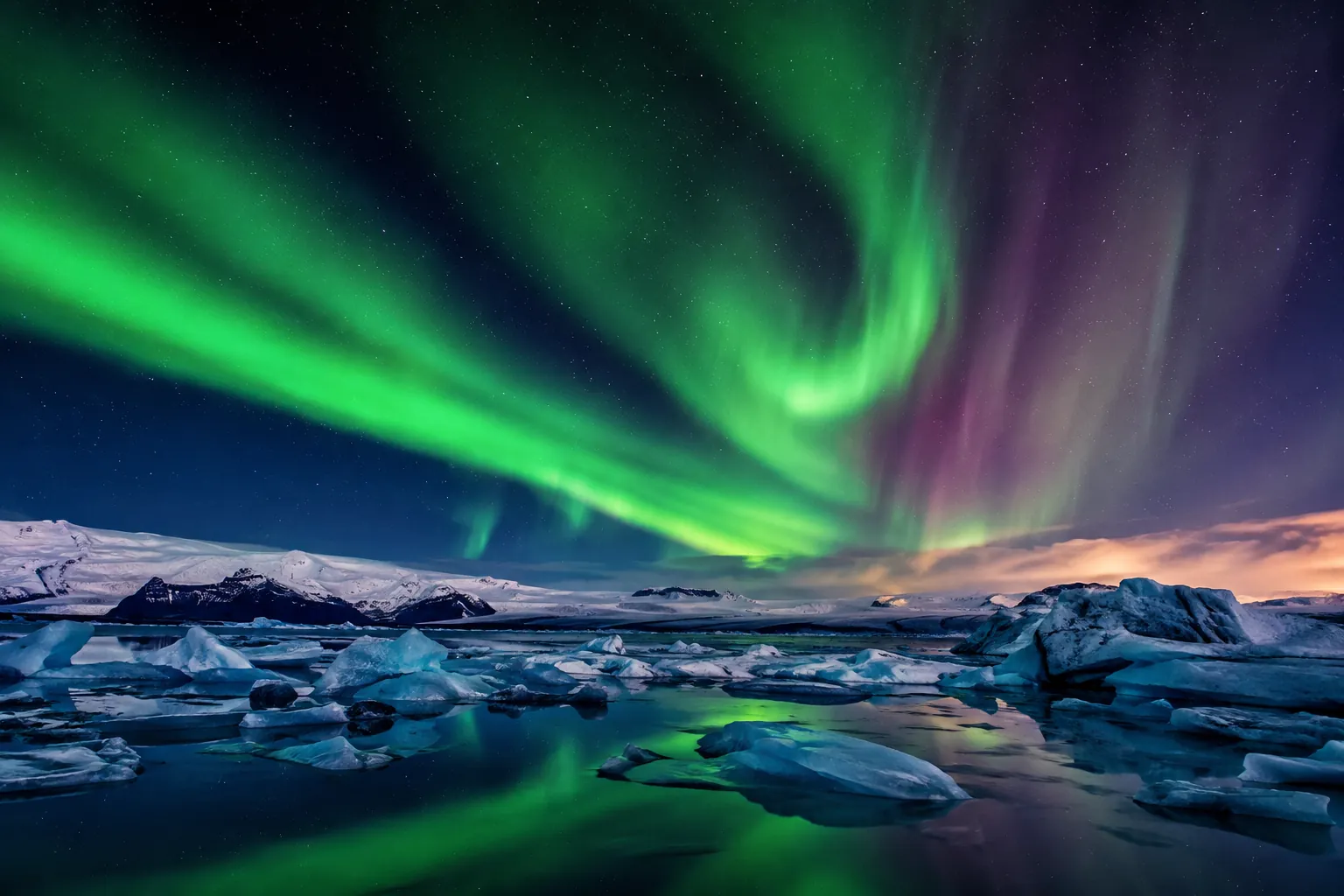 The northern lights over icebergs in a glacier lagoon in Iceland